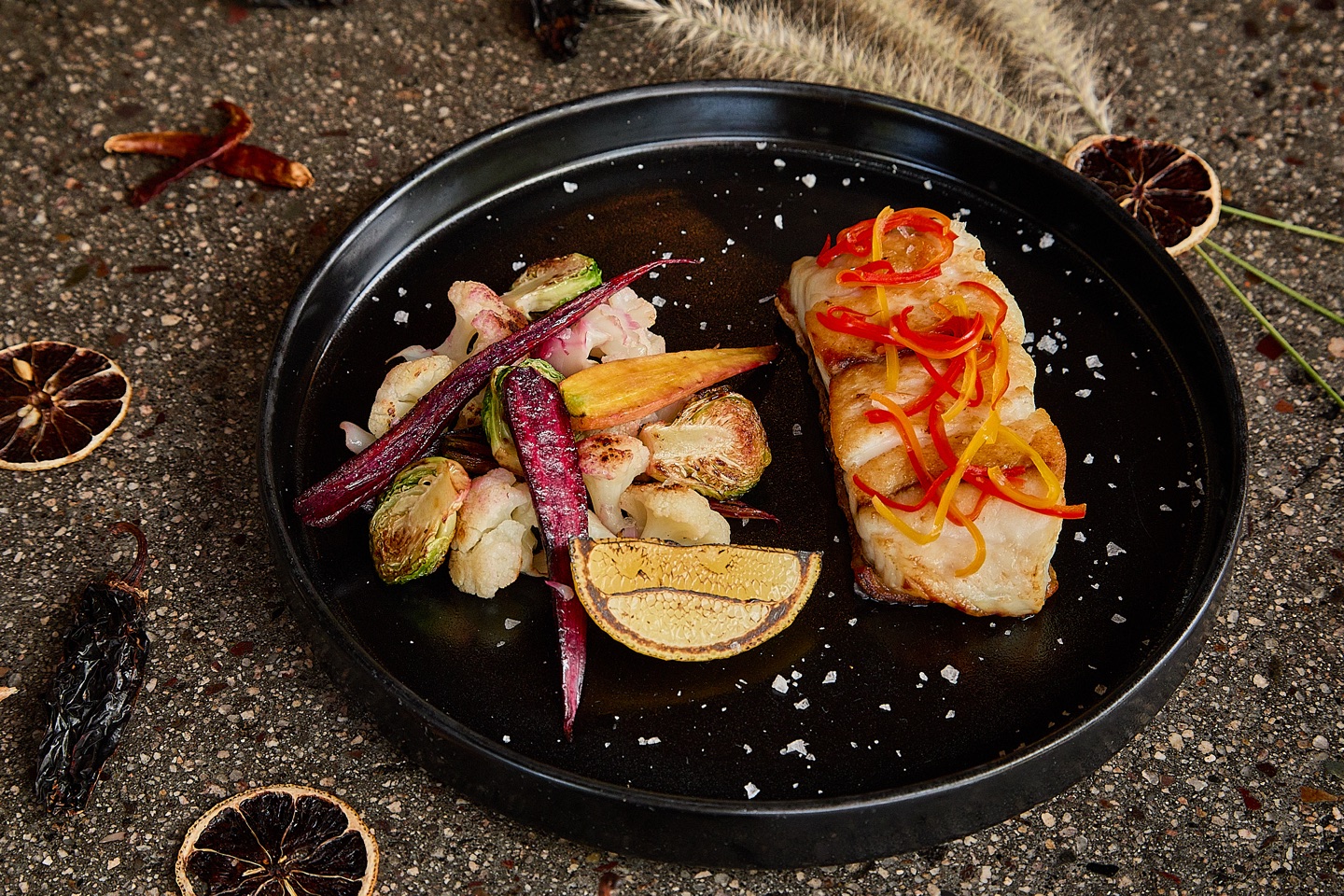 Grilled fish with seasonal vegetables styled for a hospitality menu